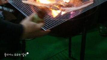 A grill with food being cooked over an open flame.