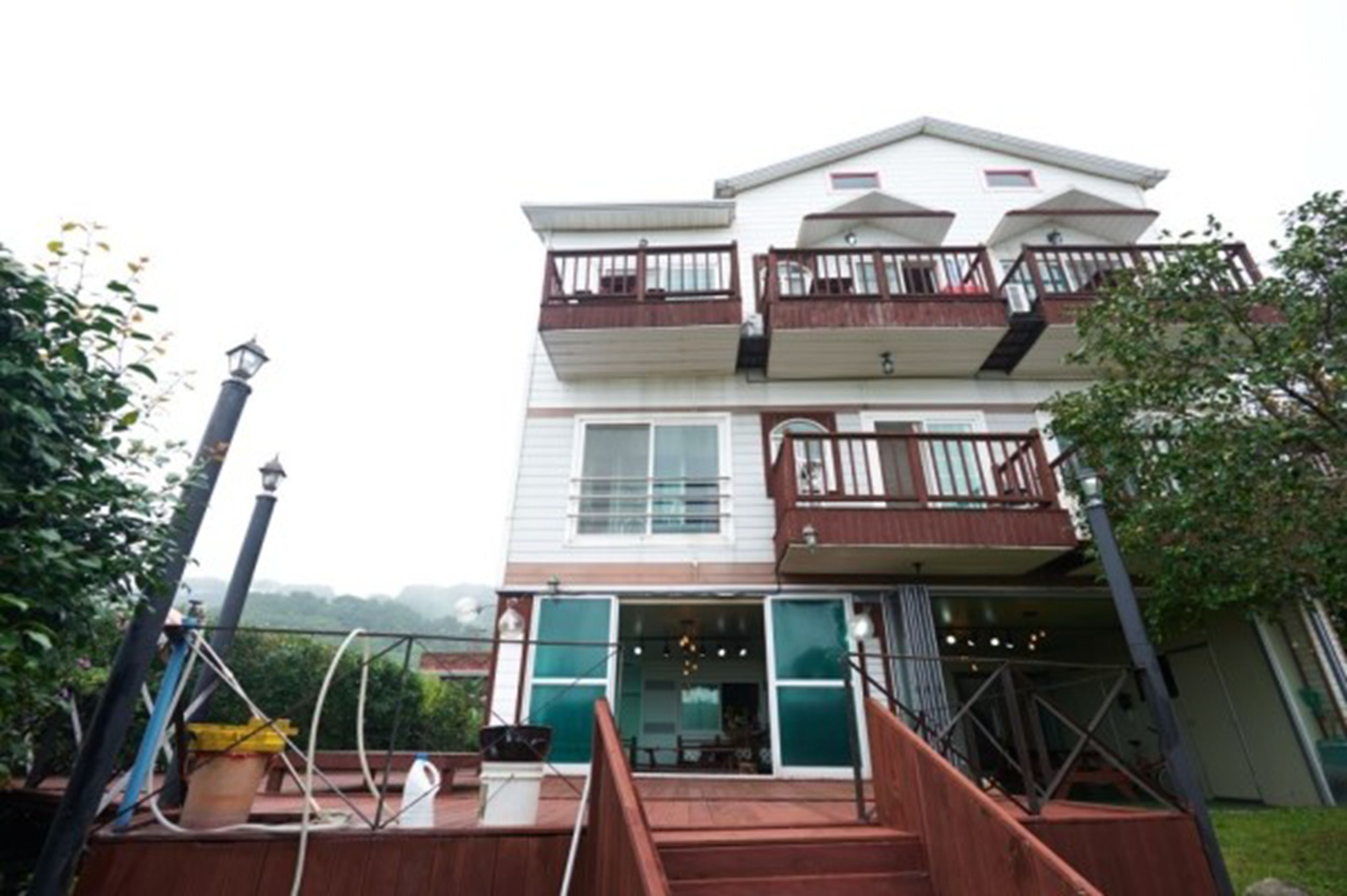 A two-story building with a balcony on the upper floor.