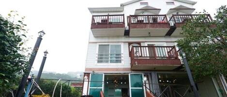 A two-story building with a balcony on the upper floor.