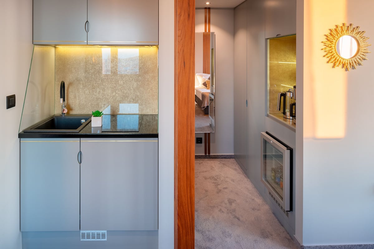 A compact kitchen with a built-in stove, a sink, and a small countertop.