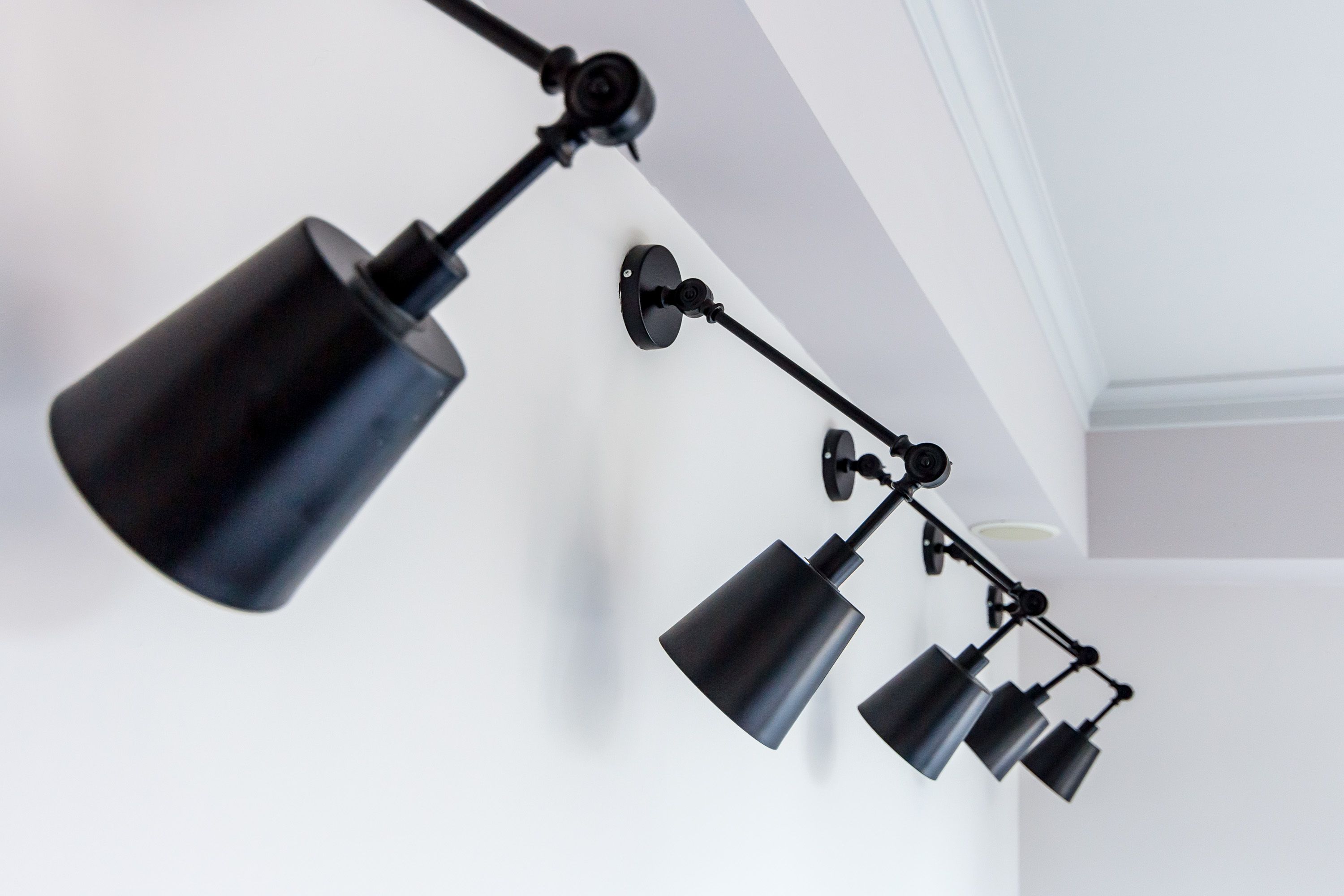 A ceiling-mounted track lighting system with multiple adjustable arms and lamps.