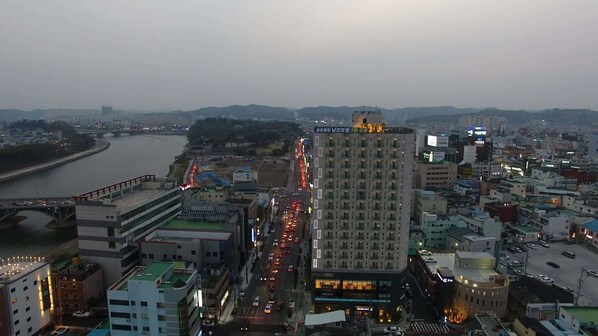 A high-rise hotel with multiple floors, a prominent sign at the top, and a busy street in the foreground.