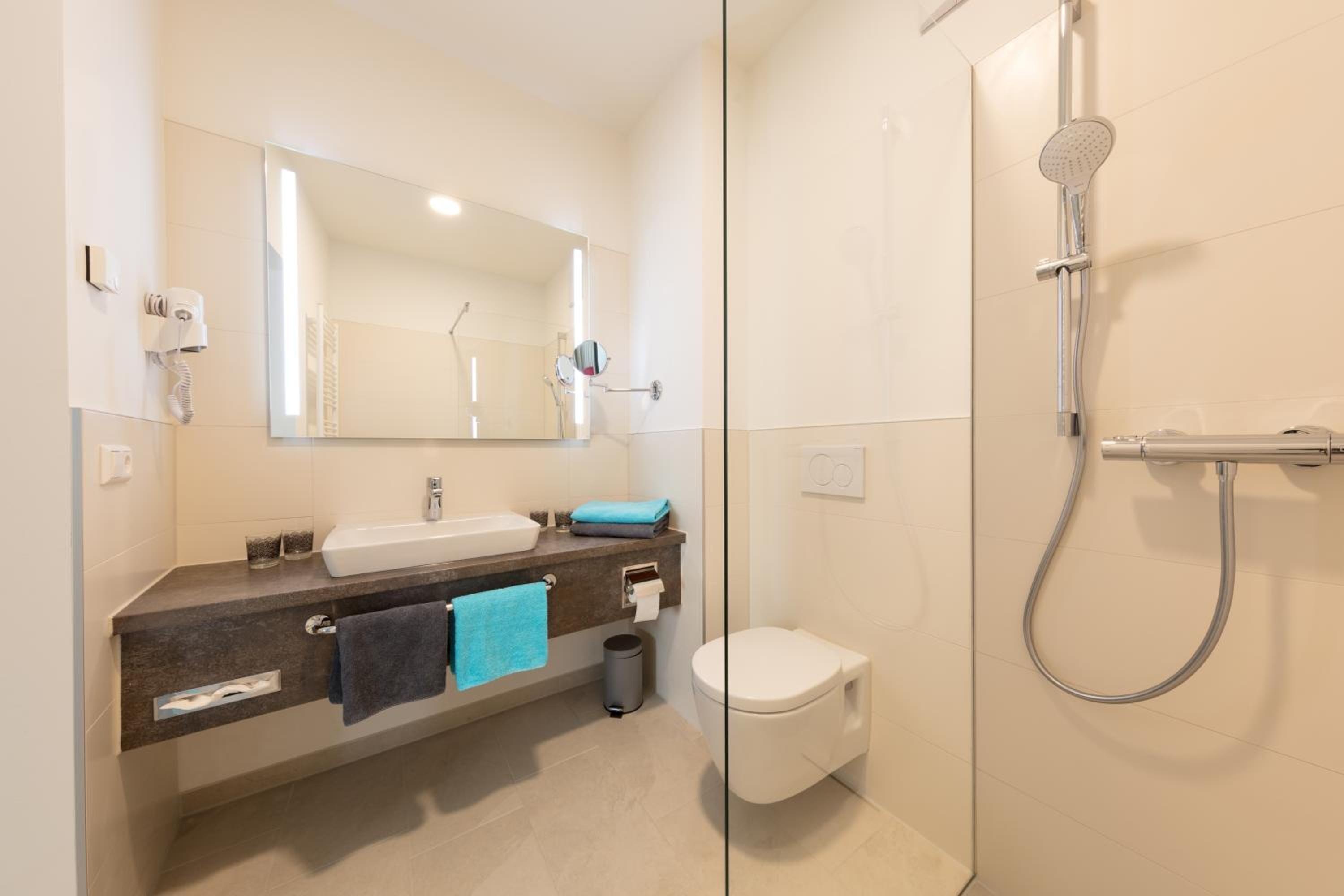 shower, hair dryer, towels, shampoo