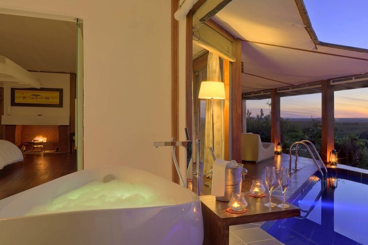 A luxurious bedroom with a large bathtub, a dining area with a view, and a poolside setting with a sunset view.