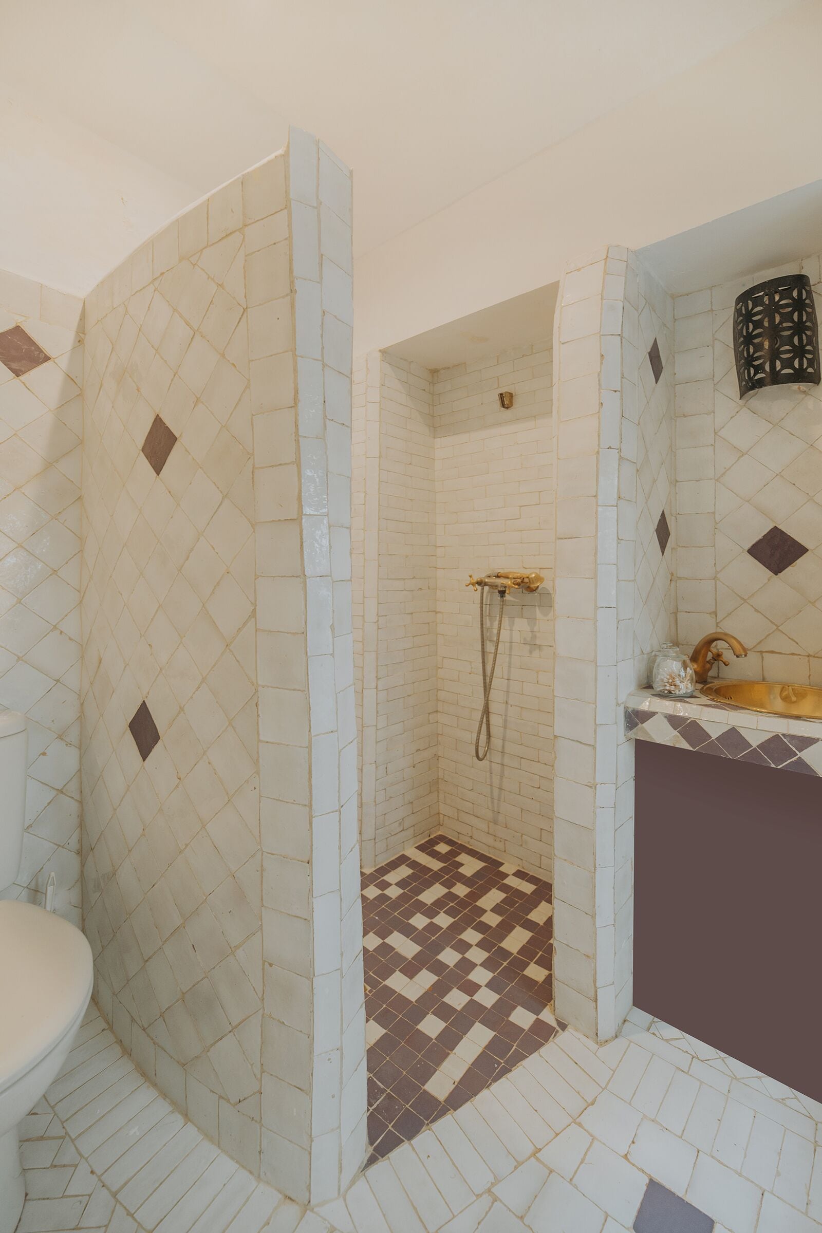 A bathroom with a shower, a toilet, and a sink.