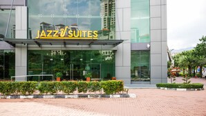 A modern building with a large glass facade and the sign "JAZZ SUITES". - May Full Seaview Luxury Suite (George Town)
