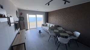 Leilighet – deluxe, 2 soverom, ikke-røyk, sjøutsikt | Oppholdsområde | En 110-centimeters Flatskjerm-TV med digitale kanaler samt LCD-TV