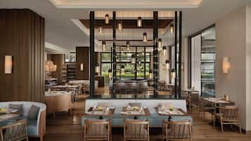 A modern restaurant with a central dining area, wooden furniture, and hanging pendant lights.