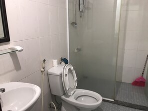 A bathroom with a toilet, bidet, and shower area. - Nancy Sweet Apartment (Ho Chi Minh City)