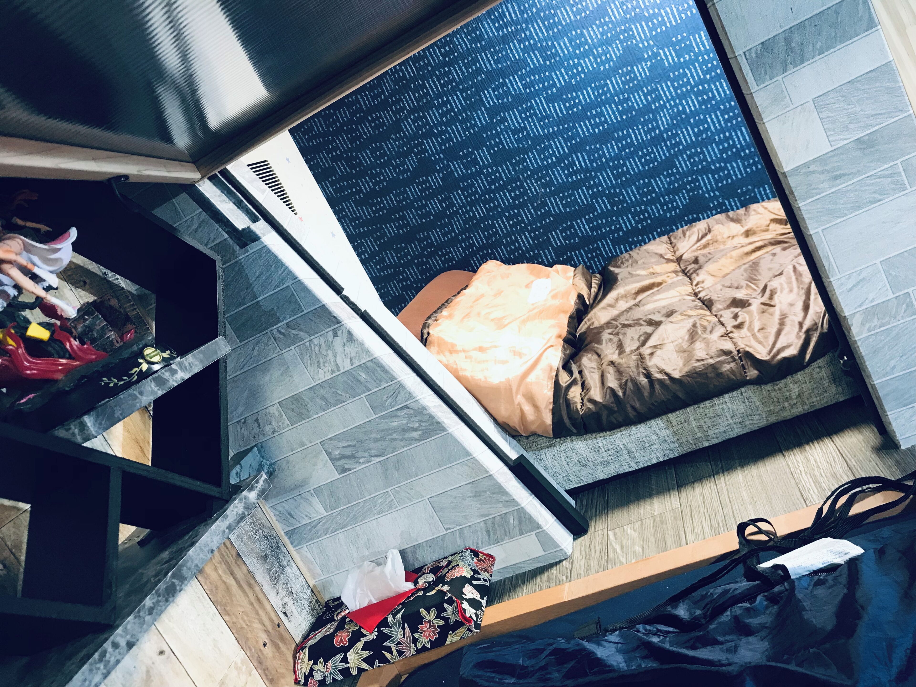 A compact room with a bed, a small table, and a chair.