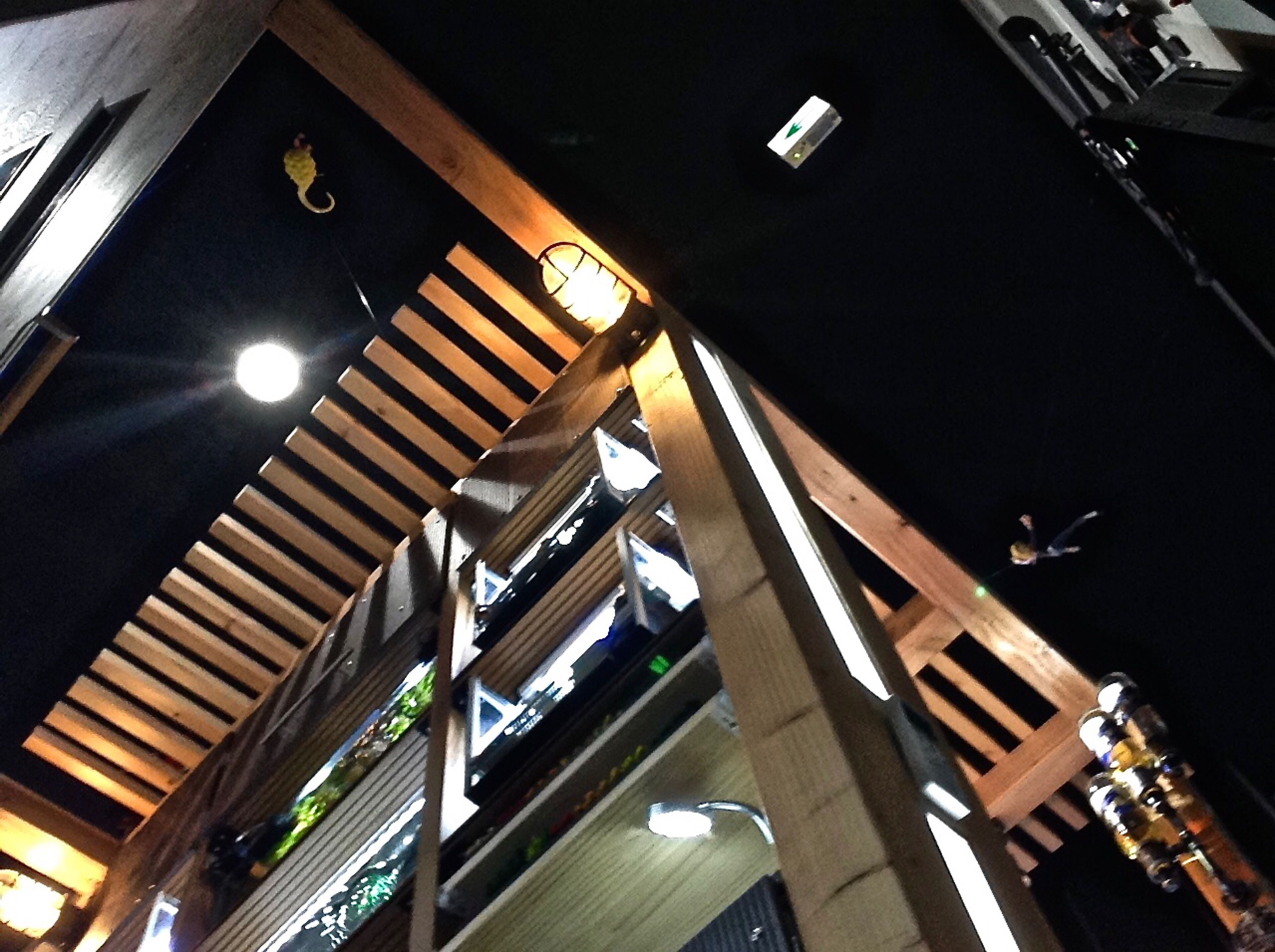 A multi-level building with wooden beams and a balcony.