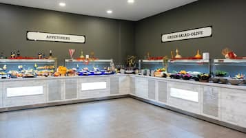 A buffet area with labeled sections for appetizers and green salad-olive.