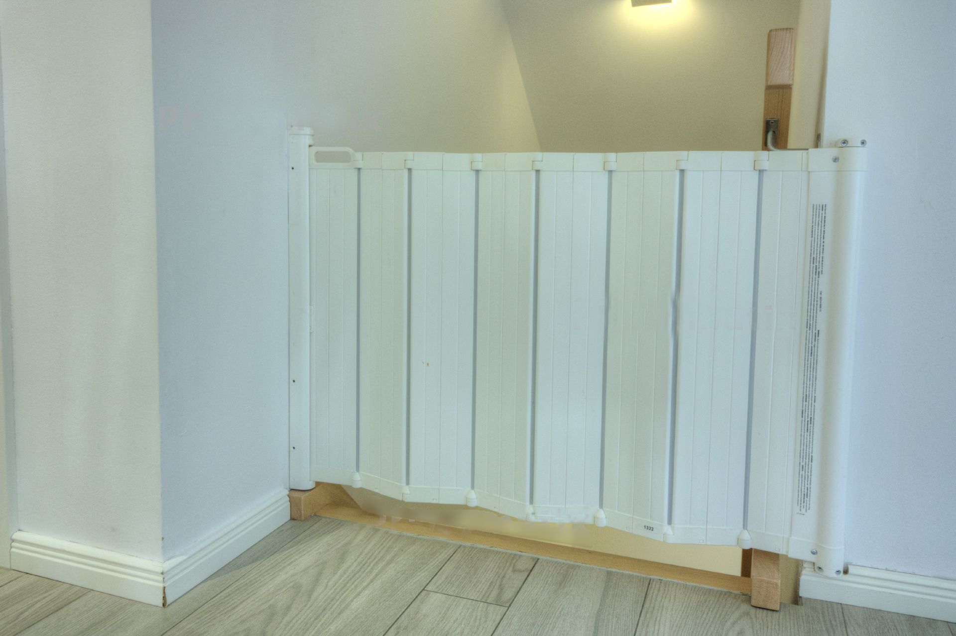 A white, wooden partition in a room with light-colored walls and flooring.