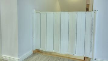 A white, wooden partition in a room with light-colored walls and flooring.