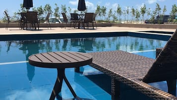 Outdoor pool, open 8:00 AM to 8:00 PM, pool umbrellas, pool loungers
