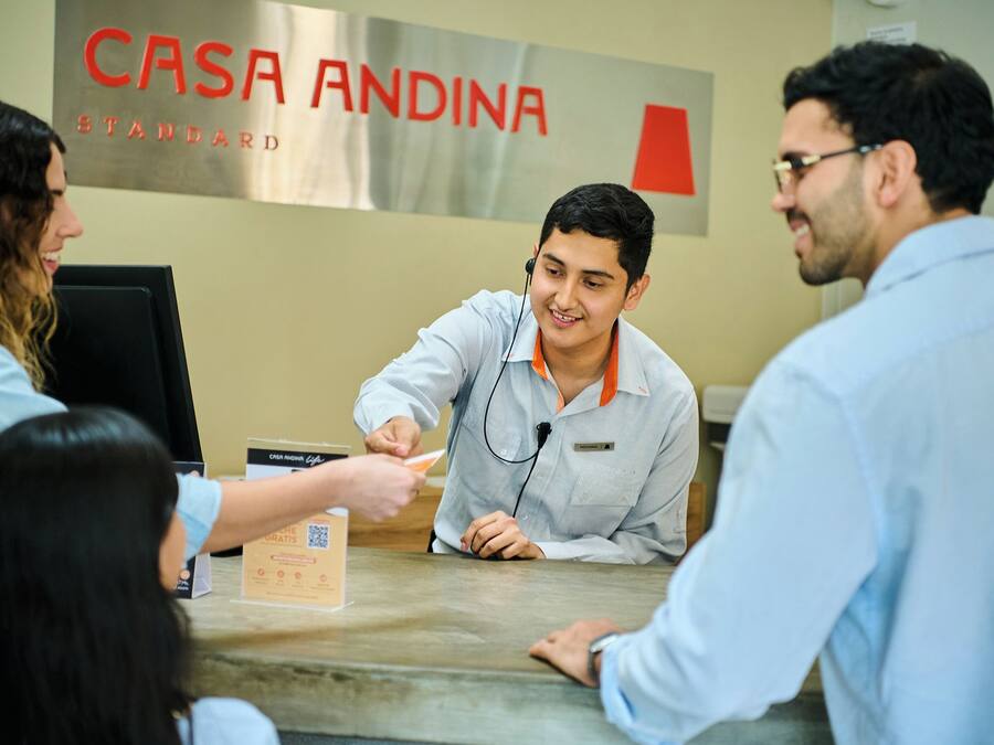 A reception desk with a sign reading 'CASA ANDINA STANDARD'.