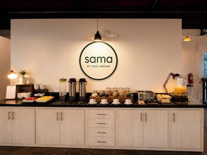 A breakfast bar with a sign reading 'sama by casa anadina,' coffee makers, a toaster, and various breakfast items. - Casa Andina Standard Ica   (Ica)