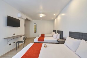A hotel room with two beds, a desk, a chair, a TV, and a ceiling light. - Casa Andina Standard Ica   (Ica)