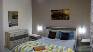A modern bedroom with a bed, nightstands, a dresser, and wall art. - Flat in Gzira 2 minutes from the sea (Gzira)