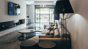 Ein modernes Wohnzimmer mit einer Couch, einem Couchtisch und einer Stehlampe.