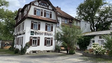 Hotel Röppe features a classic European-style facade with a steeply pitched roof and traditional shutters.