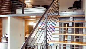 A staircase with metal railings leading to a lower level. - The Hotel Sturgis (Sturgis)
