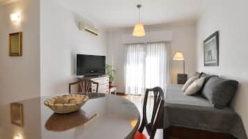 Deluxe Apartment | Living area | 32-inch Smart TV with cable channels