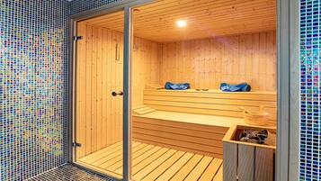 A sauna with wooden benches and a tiled wall.