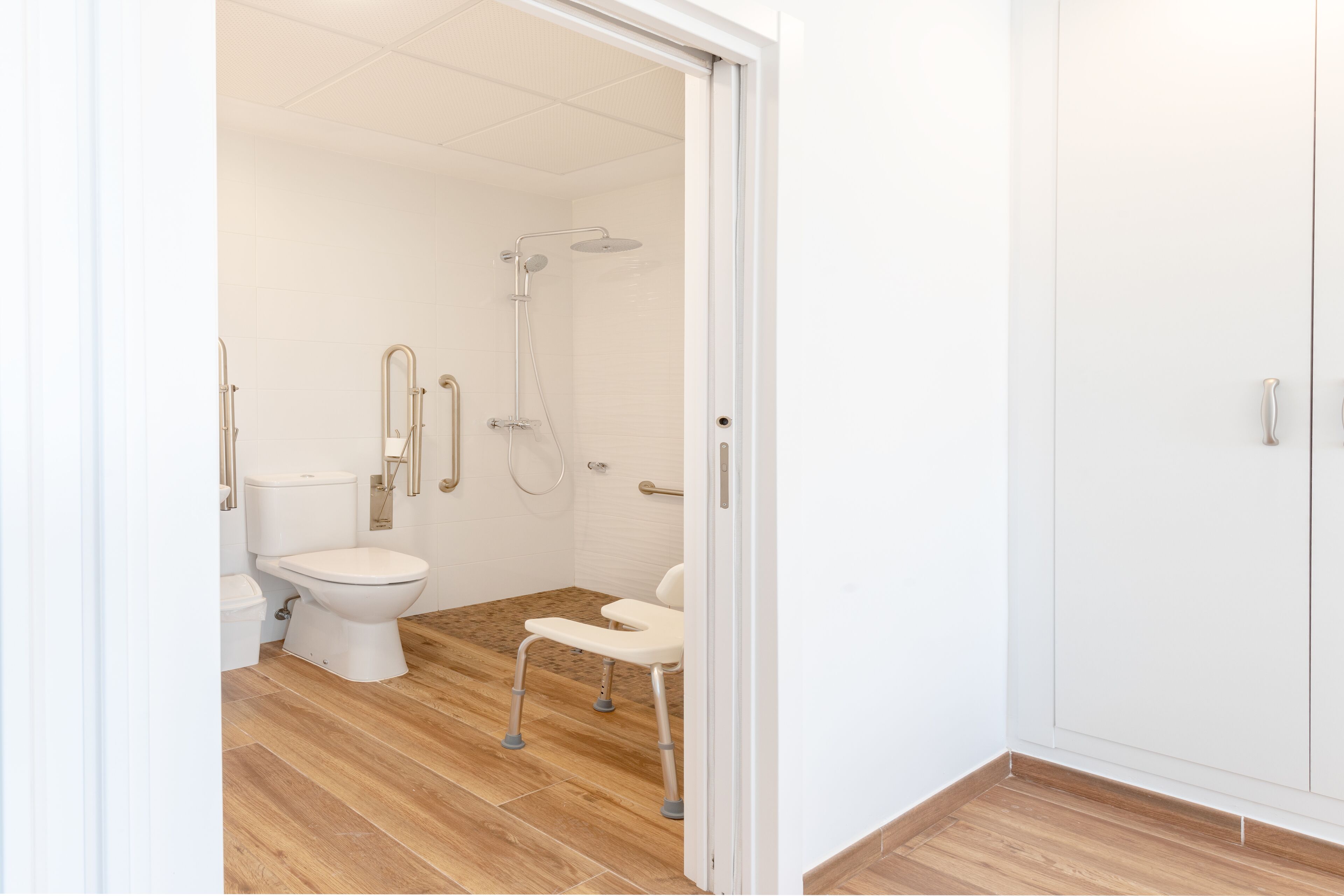 A modern bathroom with a toilet, bidet, and shower.