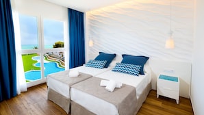 A hotel room with two beds, a view of a pool, and a white textured wall. - Aparthotel Sea Experience (Alcala de Xivert)