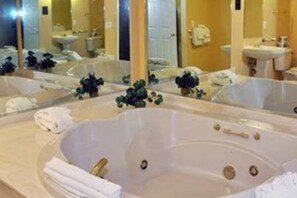 Bathroom features a bathtub and a sink with a towel.