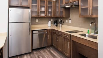 Una cucina moderna con elettrodomestici in acciaio inossidabile, mobili in legno e lavastoviglie integrata.