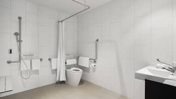 Une salle de bain moderne équipée d’une douche, de toilettes et d’un lavabo.