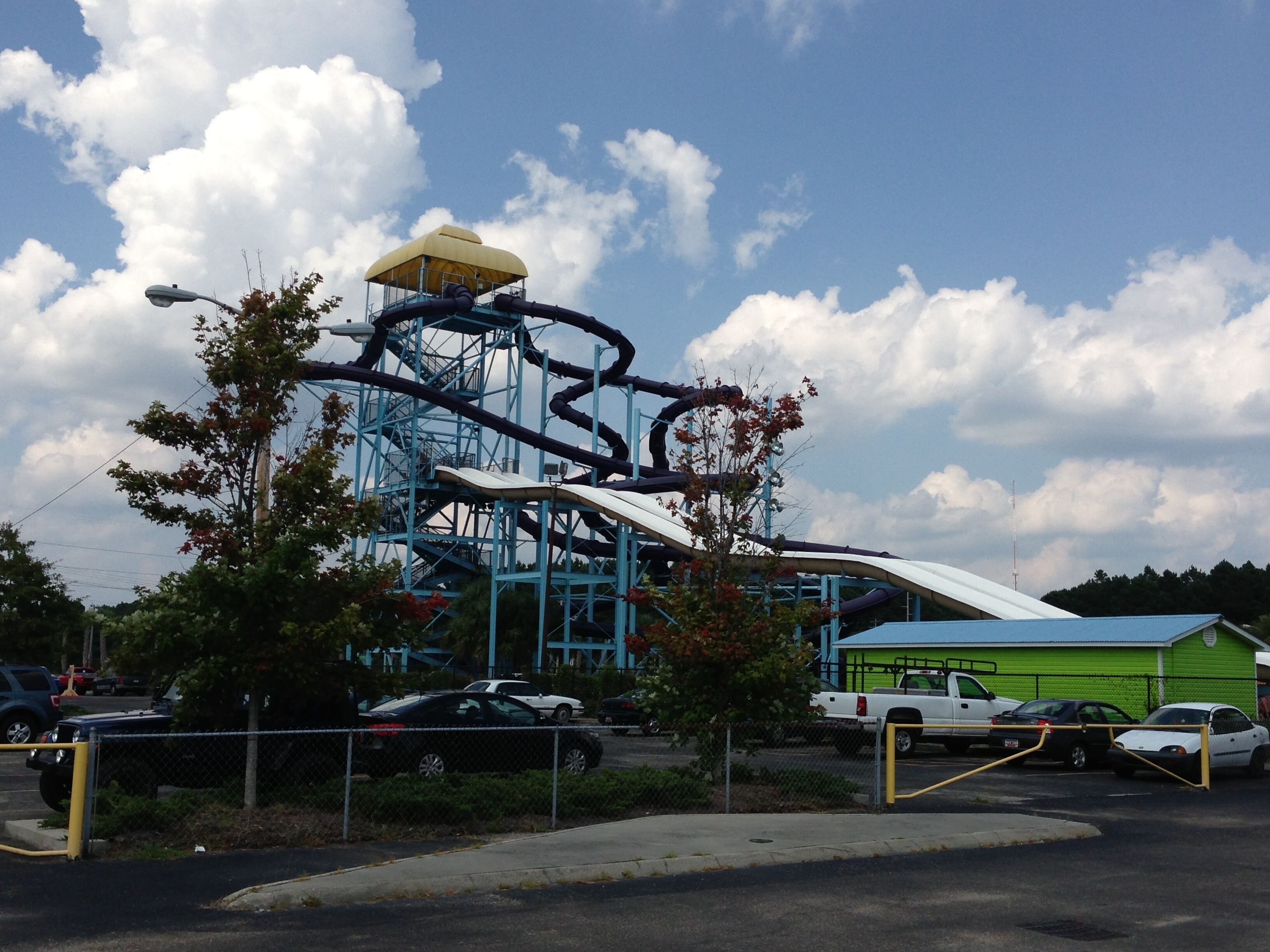 A roller coaster with a yellow top, blue support structure, and a white track.