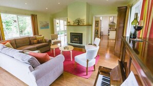 A living room with a sofa, chairs, a coffee table, and a fireplace. - Riverdale - An escape from the Yarra Valley (Wesburn)