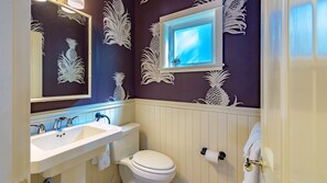 A bathroom with a white sink, a toilet, and a mirror. - **DARLING OF DUVAL @ OLD TOWN** Cottage + Spa + Last Key White Glove Service... (Key West)