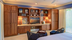 A bedroom with wooden cabinetry, a large flat-screen TV, and a desk with lamps. - **DARLING OF DUVAL @ OLD TOWN** Cottage + Spa + Last Key White Glove Service... (Key West)
