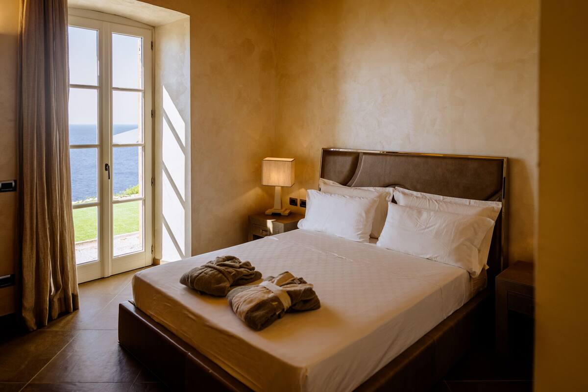 Deluxe Room, 1 Queen Bed, Patio, Sea View | 1 bedroom, minibar, in-room safe, desk