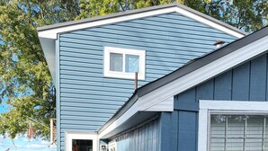 A small, single-story house with a blue exterior, a front door, and a small porch. - Chautauqua lakefront cottage🐠GREAT LOCATION 🐠Pet friendly (Jamestown)