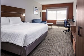A hotel room with a large bed, a desk, a chair, and a window with a view. - Holiday Inn Express & Suites Madison by IHG (Madison)