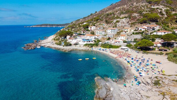 A coastal town with a beach, clear blue waters, and houses on a hillside. - Hotel La Stella (Campo nell'Elba)