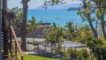 Guests at Airlie enjoy a scenic overlook of the sea and surrounding landforms from the comfort of their stay.