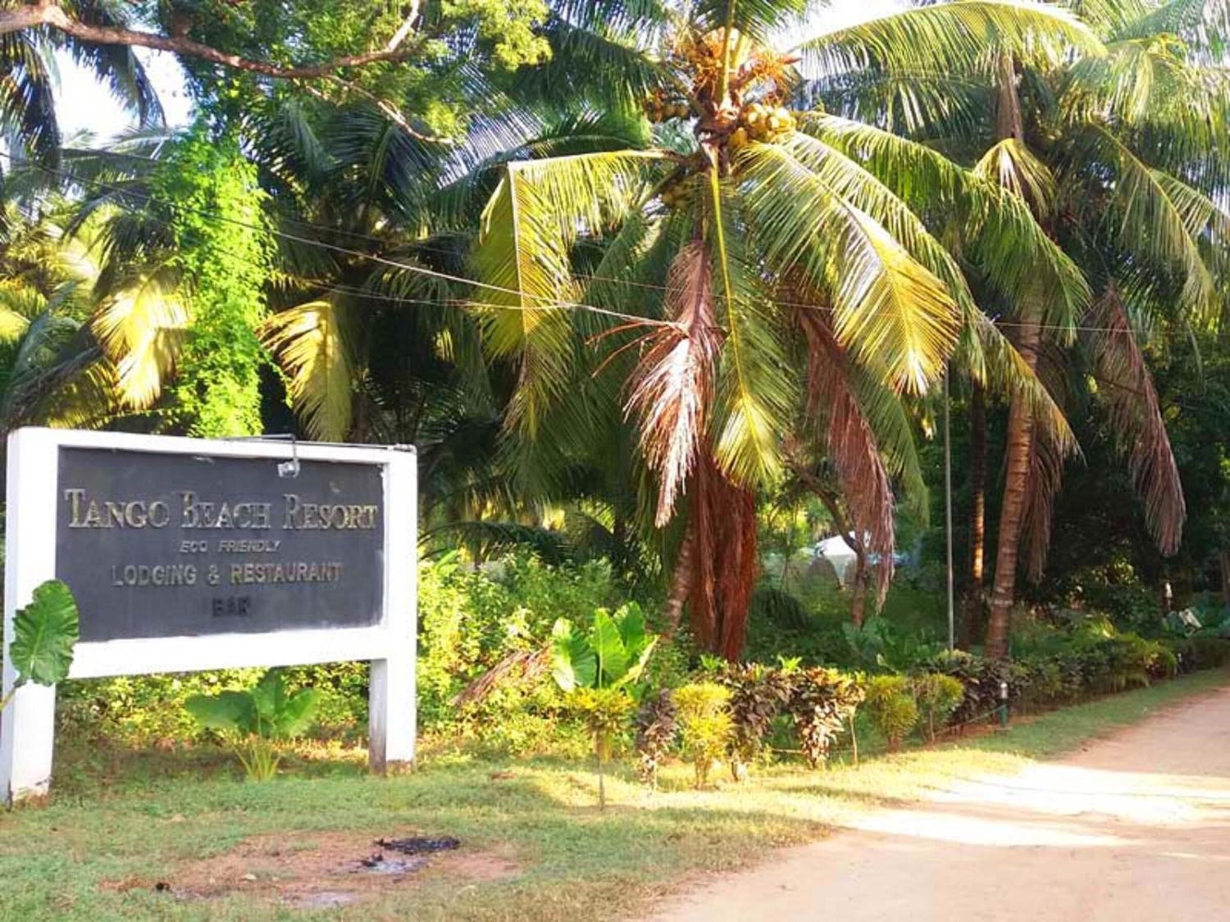 A sign for Tango Beach Resort, indicating it offers lodging and a restaurant.