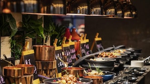 A buffet setup with various dishes and drinks. - Pullman Shanghai Qingpu Excellence (Shanghai)