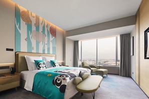 A modern hotel room with a large bed, a desk, a chair, and a view of the city. - Pullman Shanghai Qingpu Excellence (Shanghai)