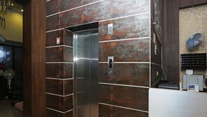 An elevator with a metallic finish, a digital display, and a control panel. - OYO 19334 Flagship Shanta Inn Charbagh (Lucknow)