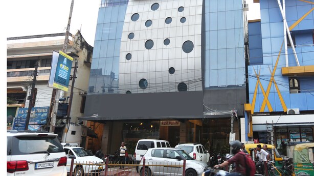 A modern building with a glass facade and circular windows. - OYO 19334 Flagship Shanta Inn Charbagh (Lucknow)