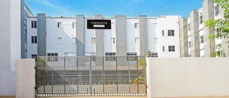 A modern building with a sign reading 'TOWNHOUSE Company Serviced'.