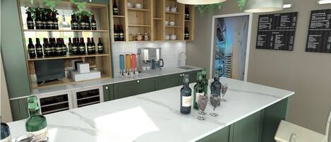 Una cocina moderna con una isla de mármol, repisas de madera con botellas de vino, una cafetera y una pizarra de menú.