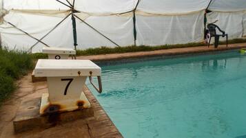A swimming pool with a lifeguard chair and a number 7 sign.